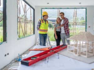 Homeowners reviewing renovation plans with a contractor before starting a residential home improvement project